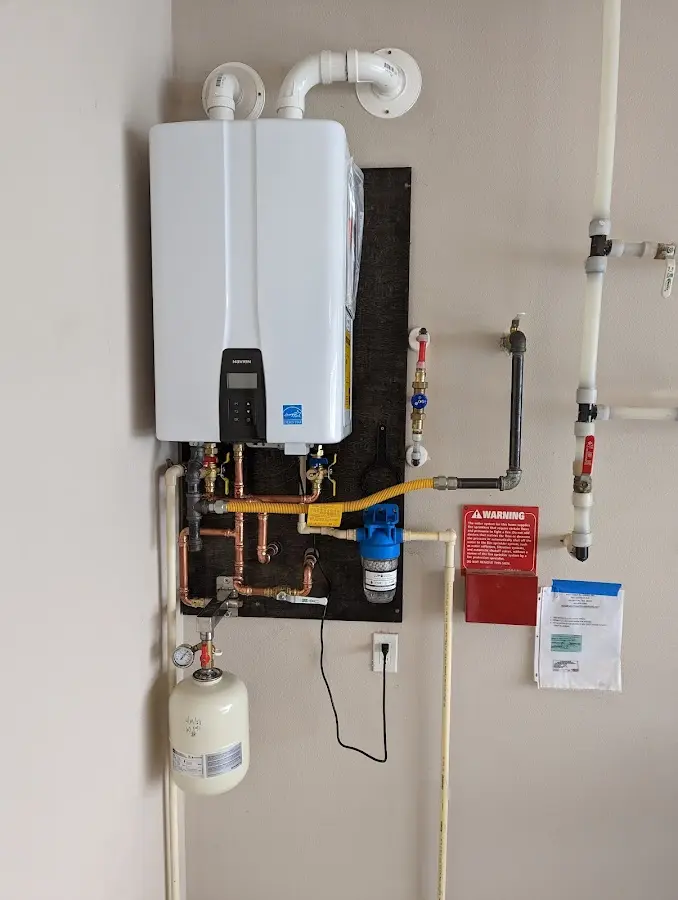 Professional plumber installing copper piping in a Hazleton home
